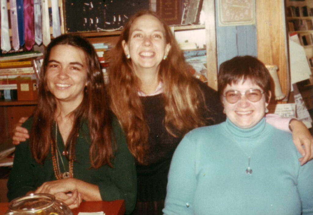 Linda Bryant with her arms around Kay Hagan, left, and Sandra Lambert, right