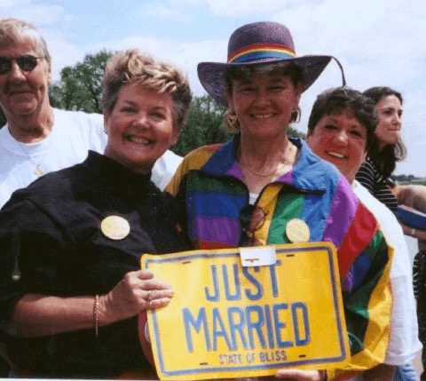 Mary Gay Hutcherson and Yolanda holding a sign saying just married state of bliss