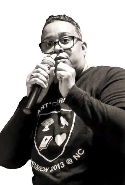 Patricia R. Corbett holding a microphone