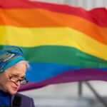 Meta Ellis with rainbow flag Mickey Welsh Advertiser