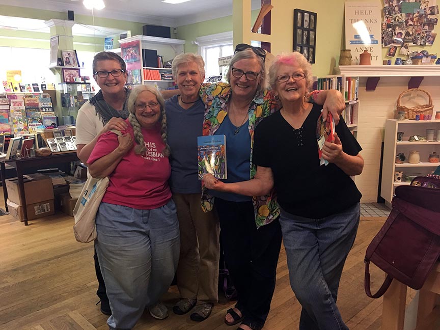 left to right Beth York Lorraine Fontana Barbara Ester Rose Norman and Gail Reeder hold book in bookstore