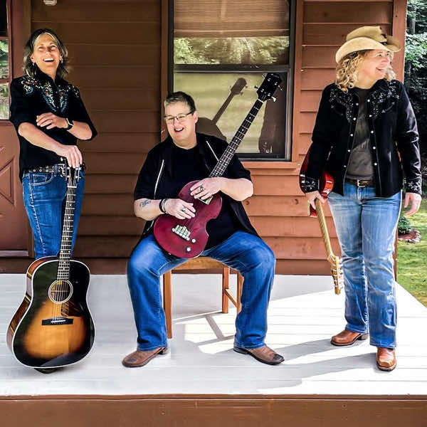 Becky standing Lenny Lasater seated and Linda standing all holding their guitars