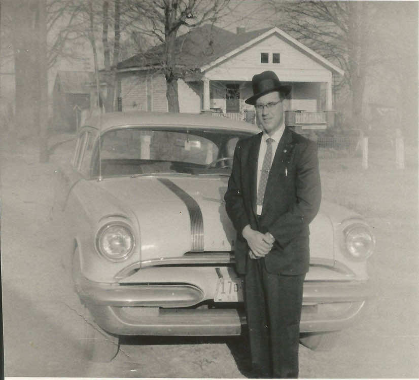 Father of Lenny Lasater photo circa 1955 dressed in suit and hat standing in front of car and home