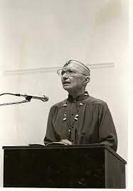 June Arnold standing at a podium