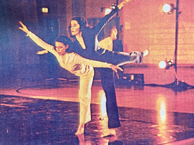 Linda Hains and Terri Barry dance posture one leg on floor the other lifted behind arms spread