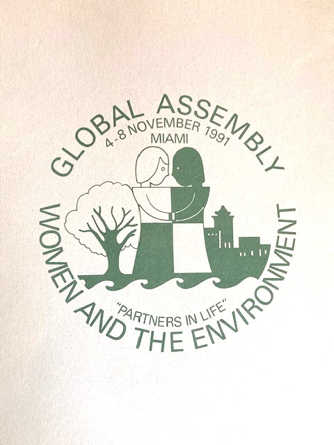 flyer for the global assembly for women and the environment picturing two women, a tree, and city background