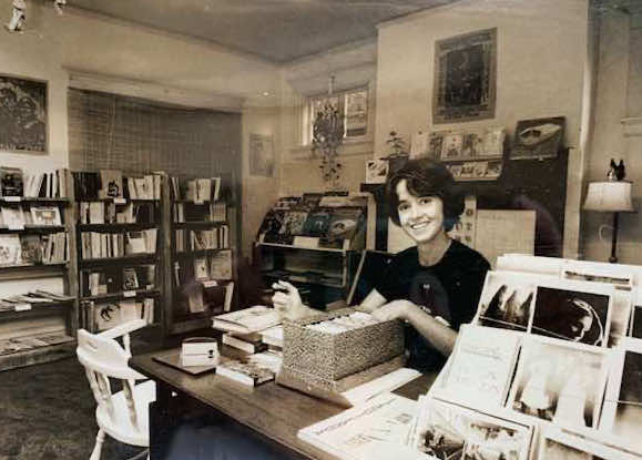 Terri Barry sitting at desk inside Labrys Books