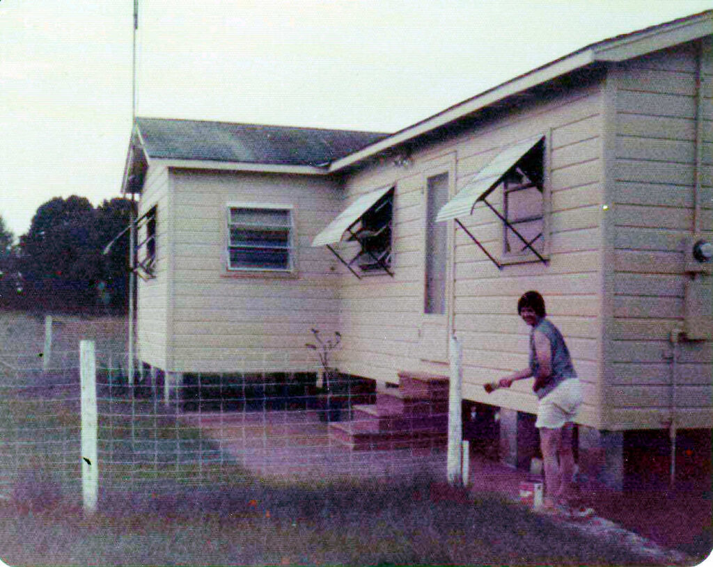 Exterior view of farm house at Womanworld being painted by Shewolf