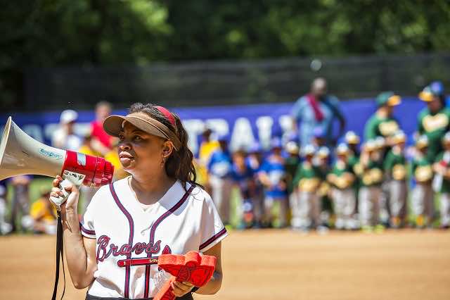 Kecia Cunningham holding bull horn at Braves youth baseball game