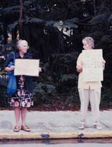Ruth Dreamdigger and Blue Lunden holding signs