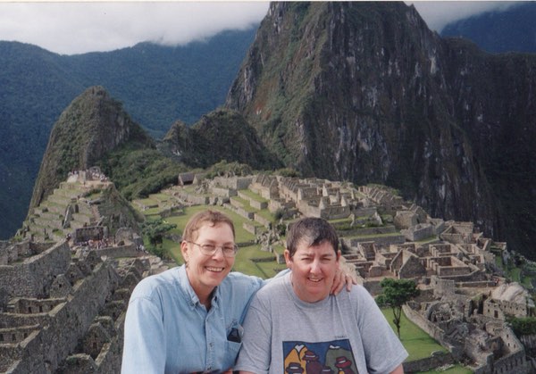 Leaf and Drea in foreground with ruins of Machu Picchu and mountains behind them