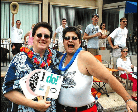 Lenny Lasater holding a sign saying I do! with Cherry Omega