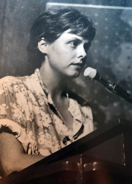 Jan Gibson at microphone reads her poetry