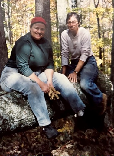Jes Ryn and Cedar Heartwood sitting on fallen tree