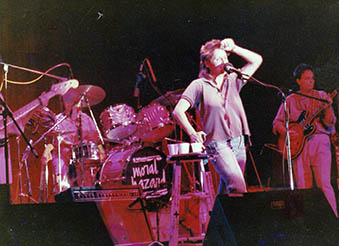 Jan Gibson singing on stage with the band