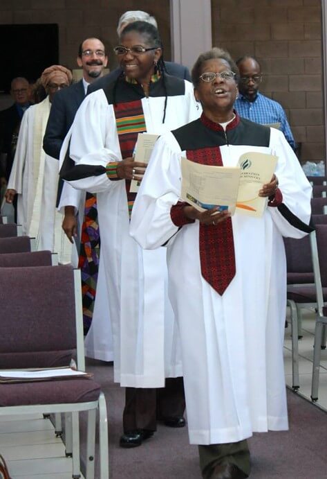 Carolyn Mobley-Bowie and her spouse Adrain Mobley-Bowie in choir robes