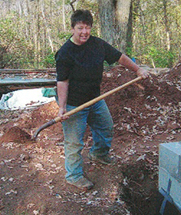 Nett is outdoors wielding a shovel.