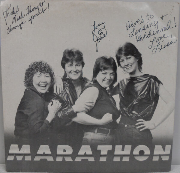 signed by Marathon members Regina Cates, Josie Grable, and Lissa LeGrand the front of a 45 record from 1984