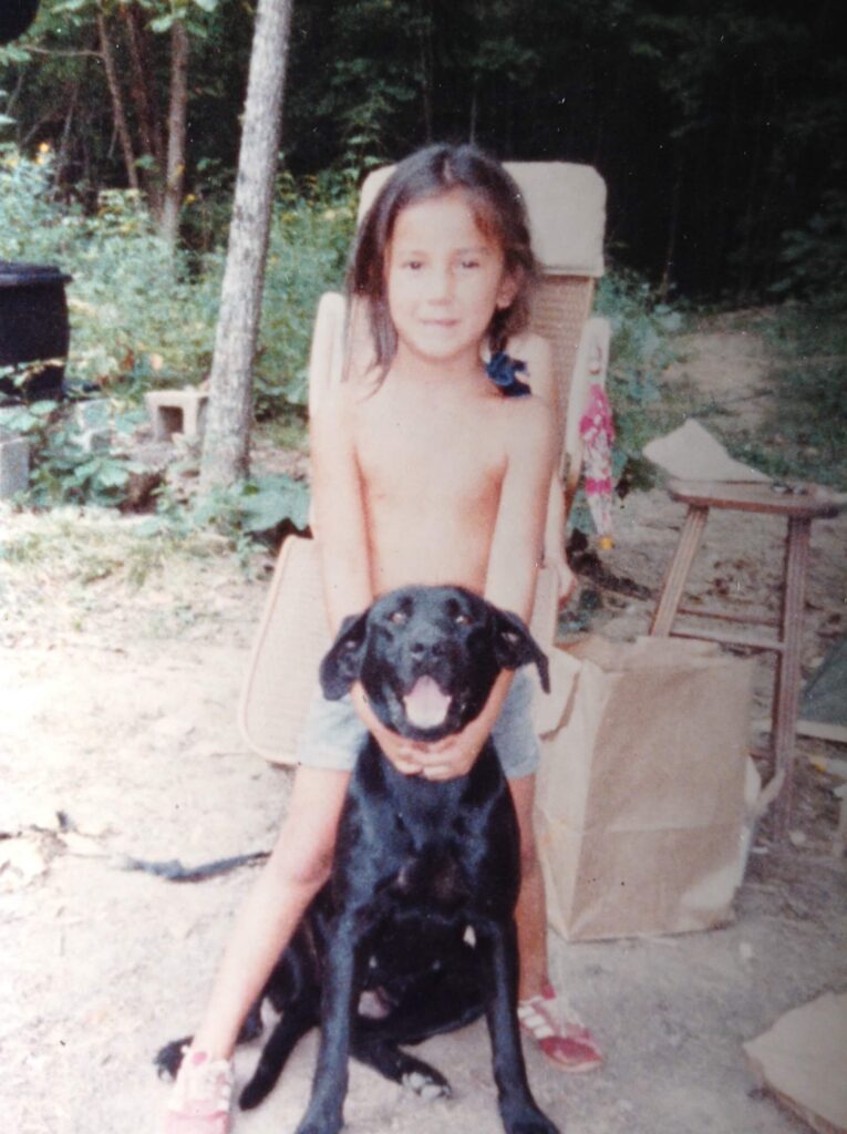 young girl with black dog