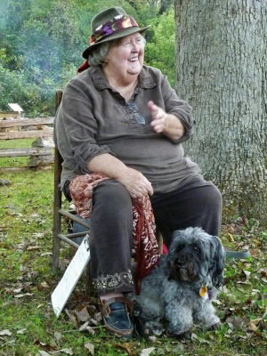 Marideth Sisco, seated, with her dog.