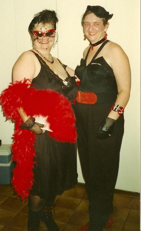 Mary Dean Carter wearing red sunglasses and red feather boa