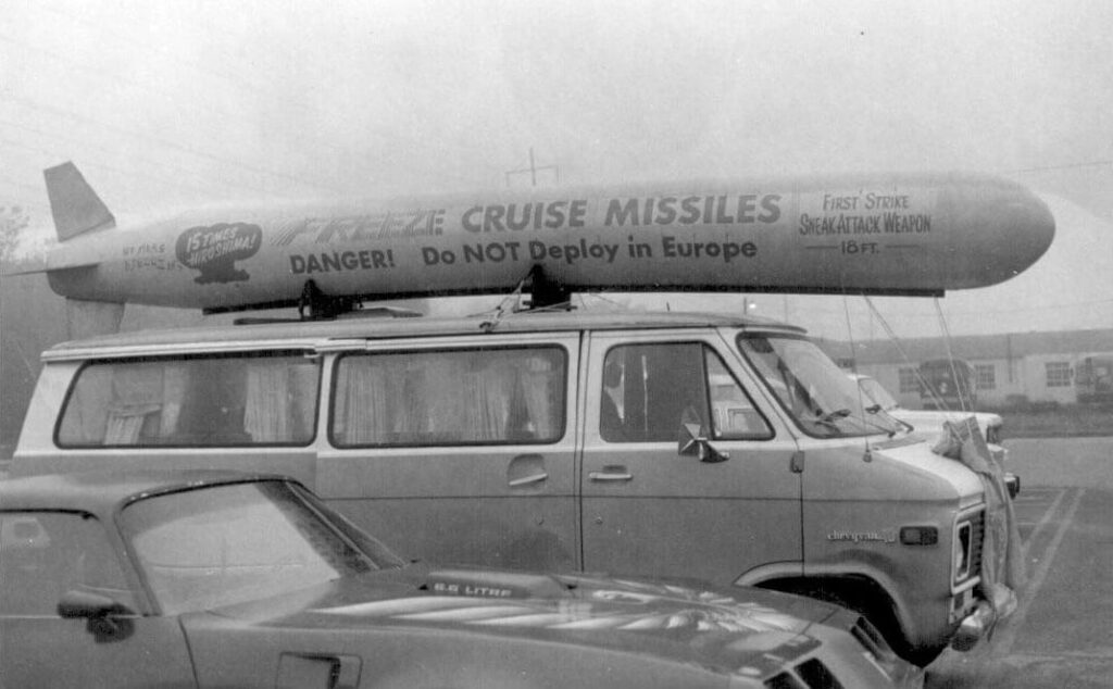 Large van with a nuclear missile model on top saying freeze cruise missiles and danger do not deploy in Europe and more