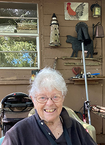 Rainbow Williams smiling in front of her Saint Augustine house